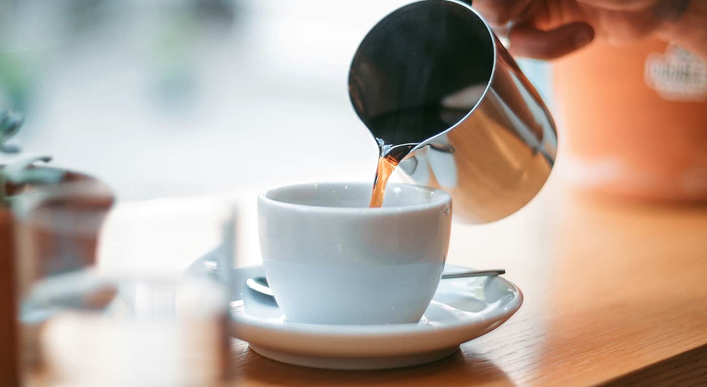 Visitors walk near Himeji Castle as tourists explore the historic site under bright daytime conditions