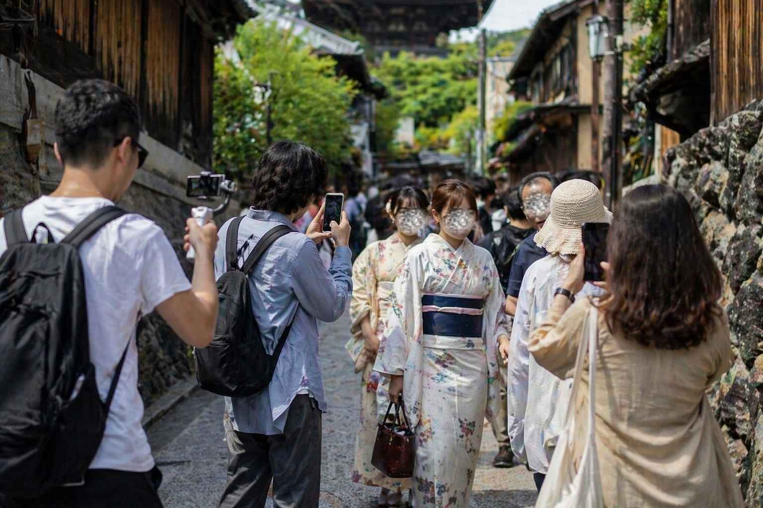 Visitors walk near Himeji Castle as tourists explore the historic site under bright daytime conditions